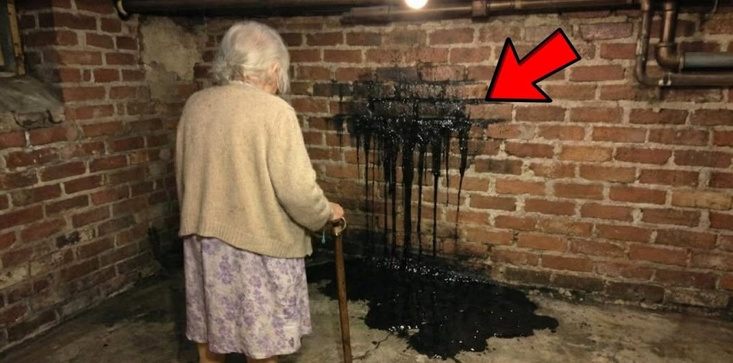Mulher encontra líquido preto na parede do porão – olha o que há por trás e chama seu advogado!